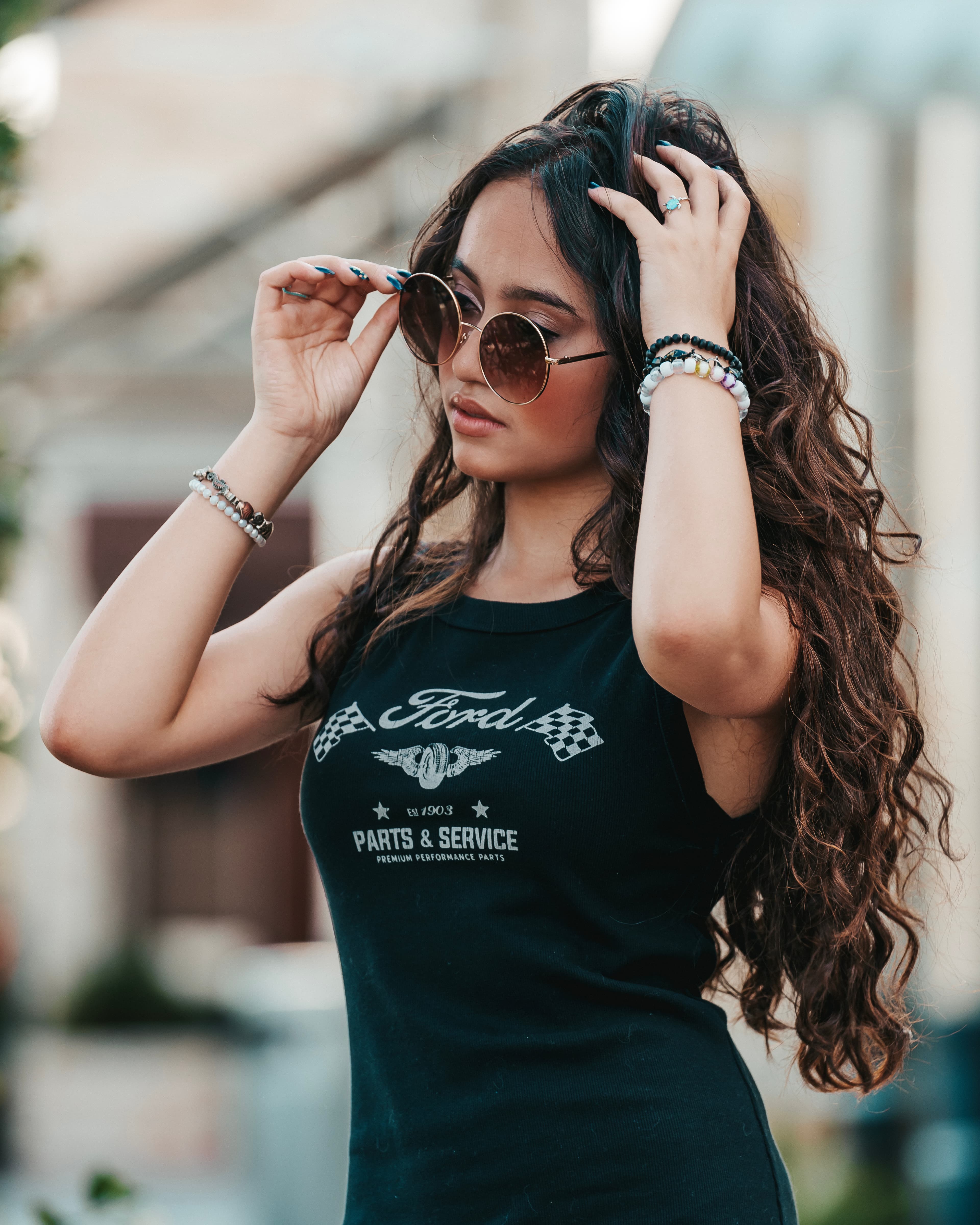 Fashion portrait adjusting sunglasses