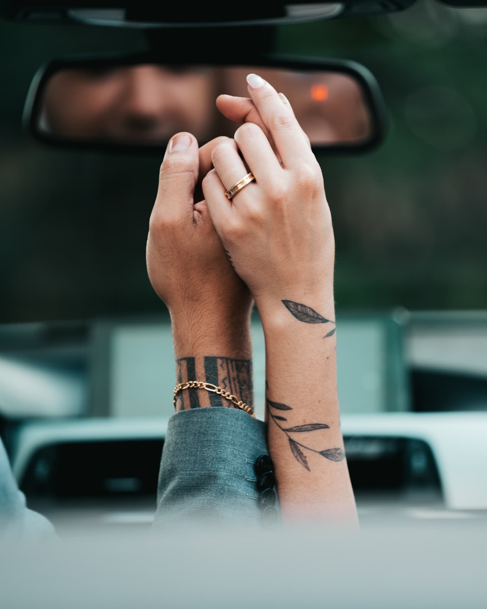 Couple hands in car, mirror reflection
