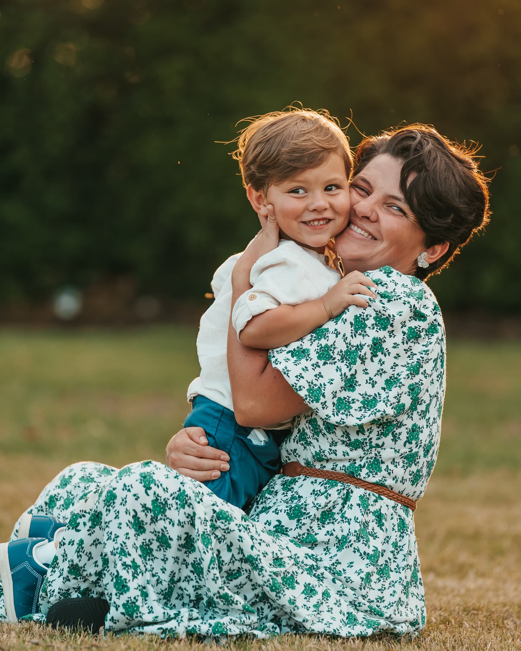 Mother and son hugging at sunset