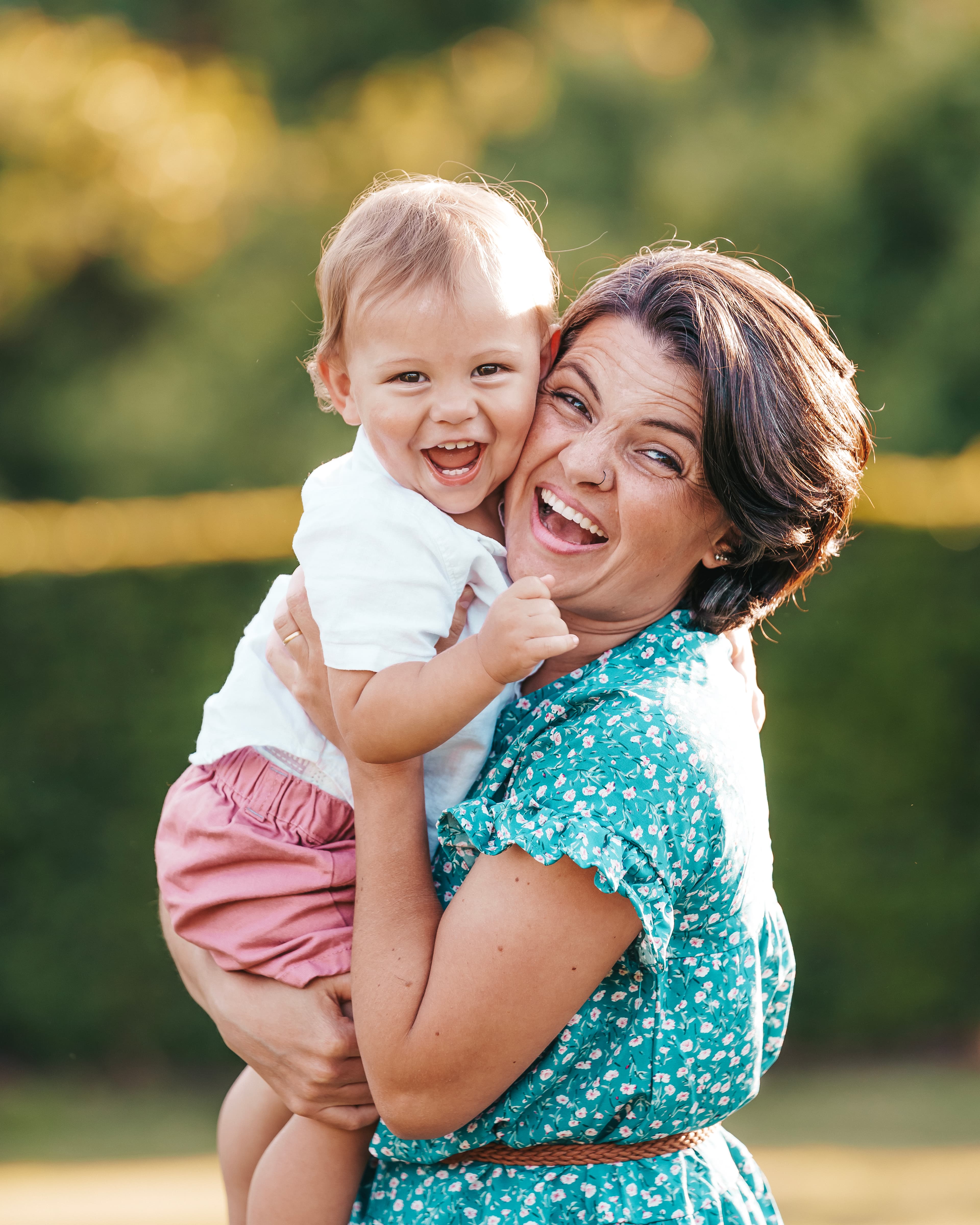 Mother and baby laughing in golden hour
